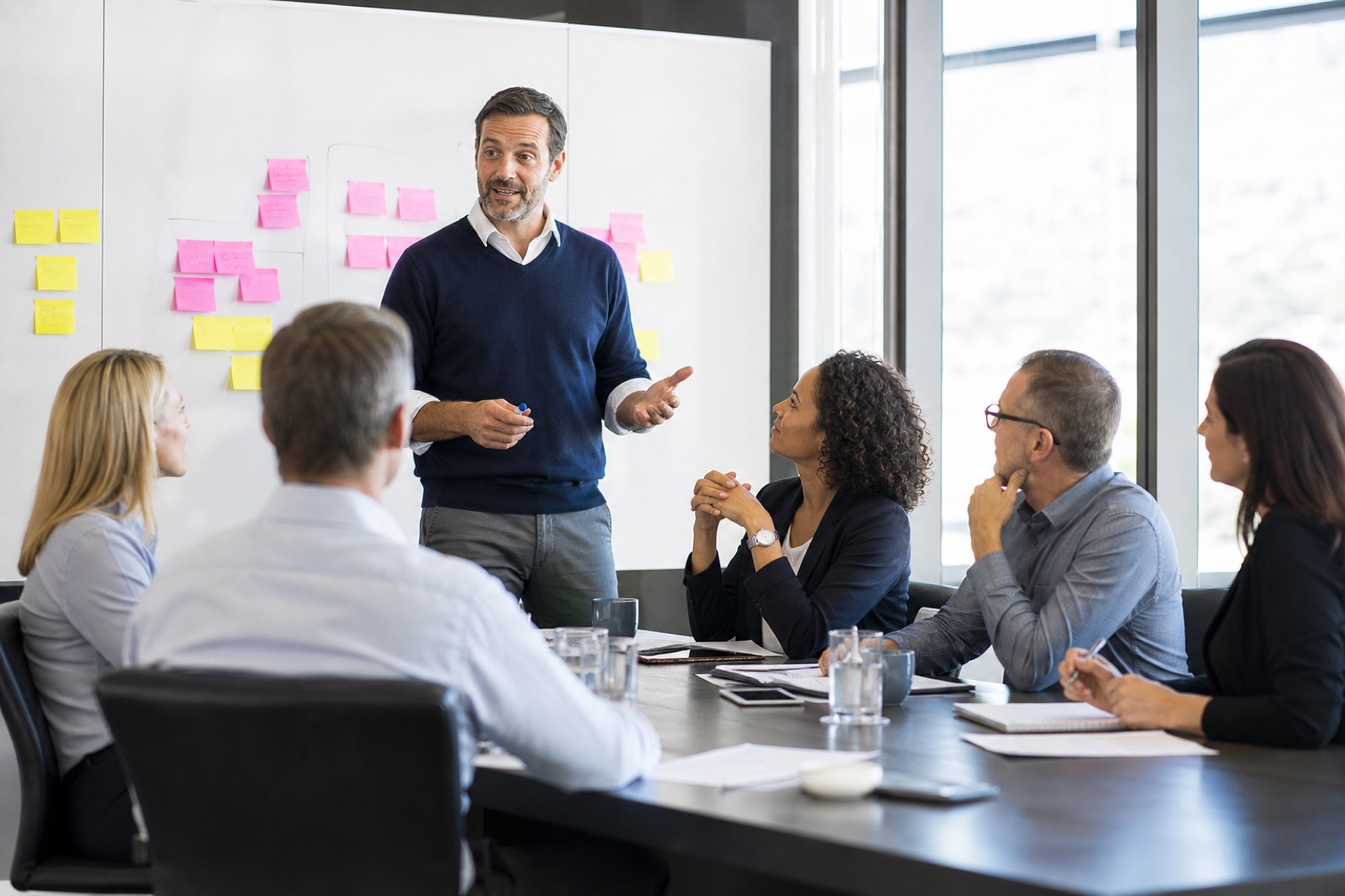Michael facilitating a communication workshop around a boardroom table